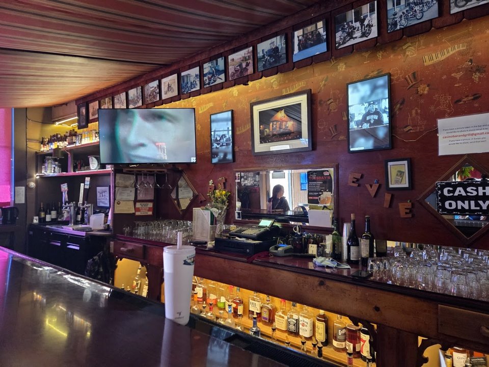 Casual bar seating beside a wooden counter.